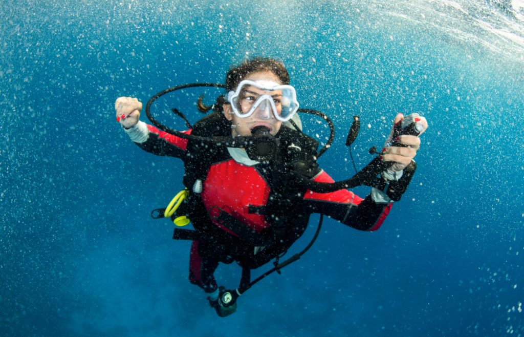 A scuba diver ascending slowly underwater