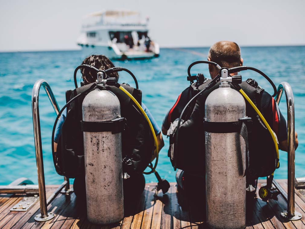 Scuba divers sitting after scuba diving