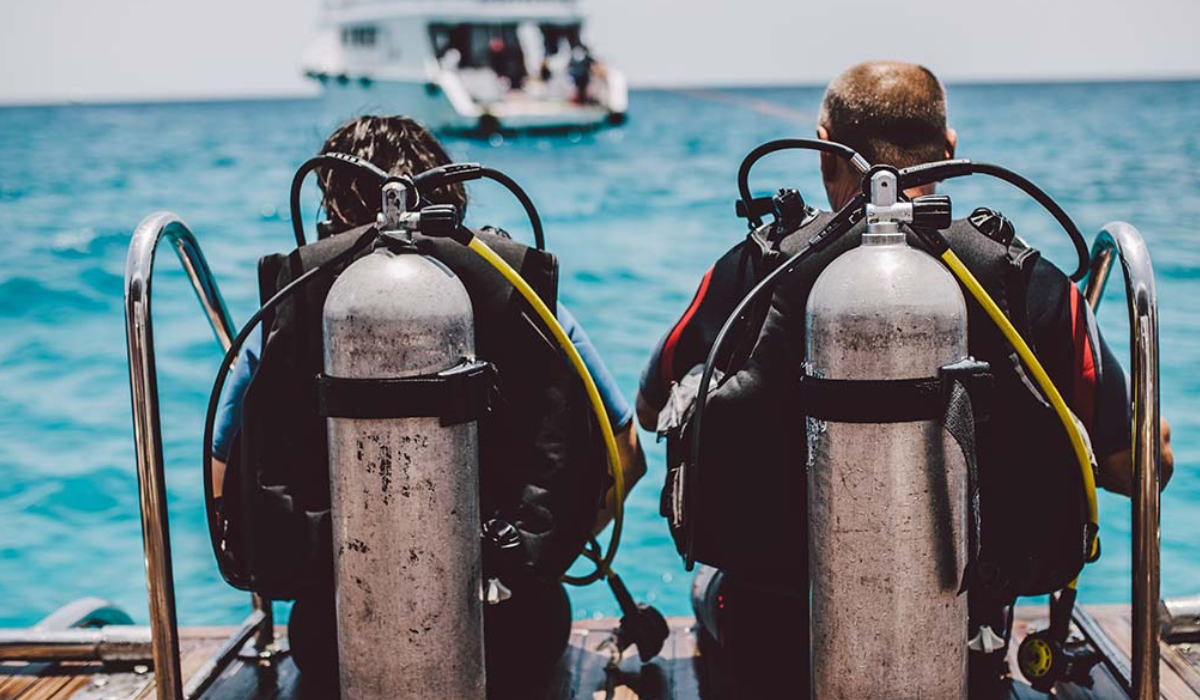 Scuba divers sitting after scuba diving